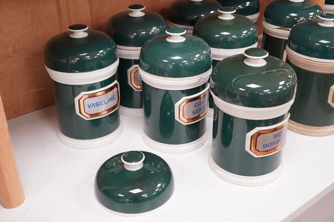 A collection of sixteen 19th/early 20th century ceramic lidded green apothecary jars, with labels painted within panels with raised ceramic edges and gilt lined, examples including; Ung: Zinci, Ung: Sulphur:, Mel: Boraci
